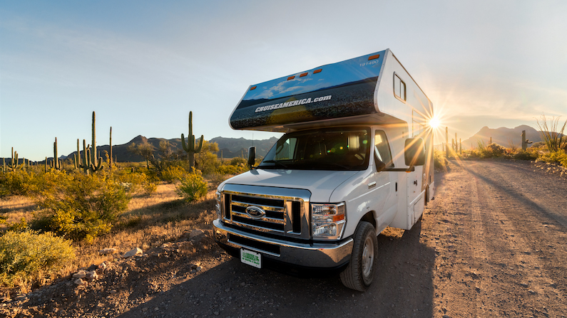 RV on dirt road in Arizona at sunset