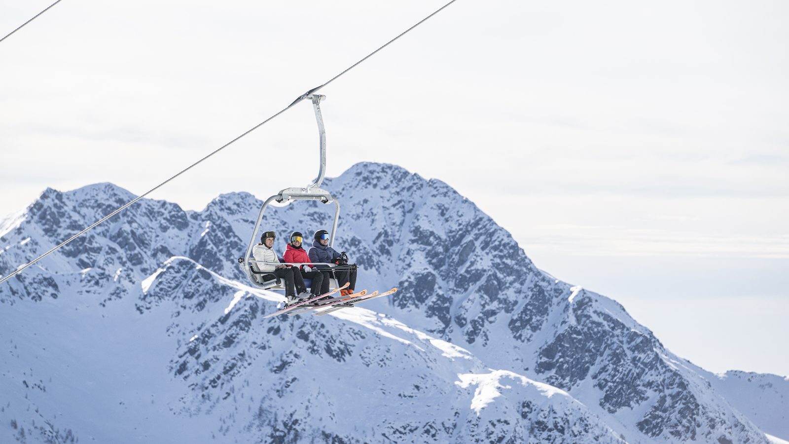 Skiers on chairlift at Dolomiti Superski