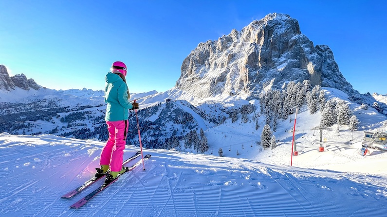 Skier looking at mountain views during winter in Val Gardena, Italy