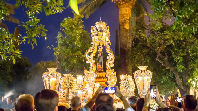 A large statue is carried during Semana Santa in Seville, Spain